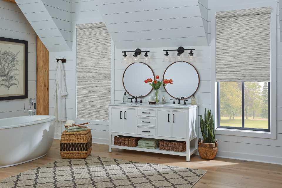 natural roller shades in rustic bathroom with shiplap walls and deep soak tub